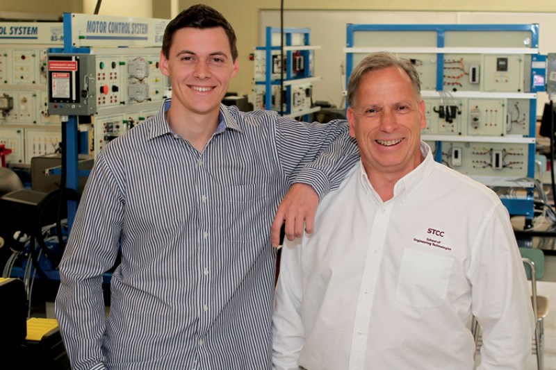An Energy Systems Technology student monitors an HVAC device.