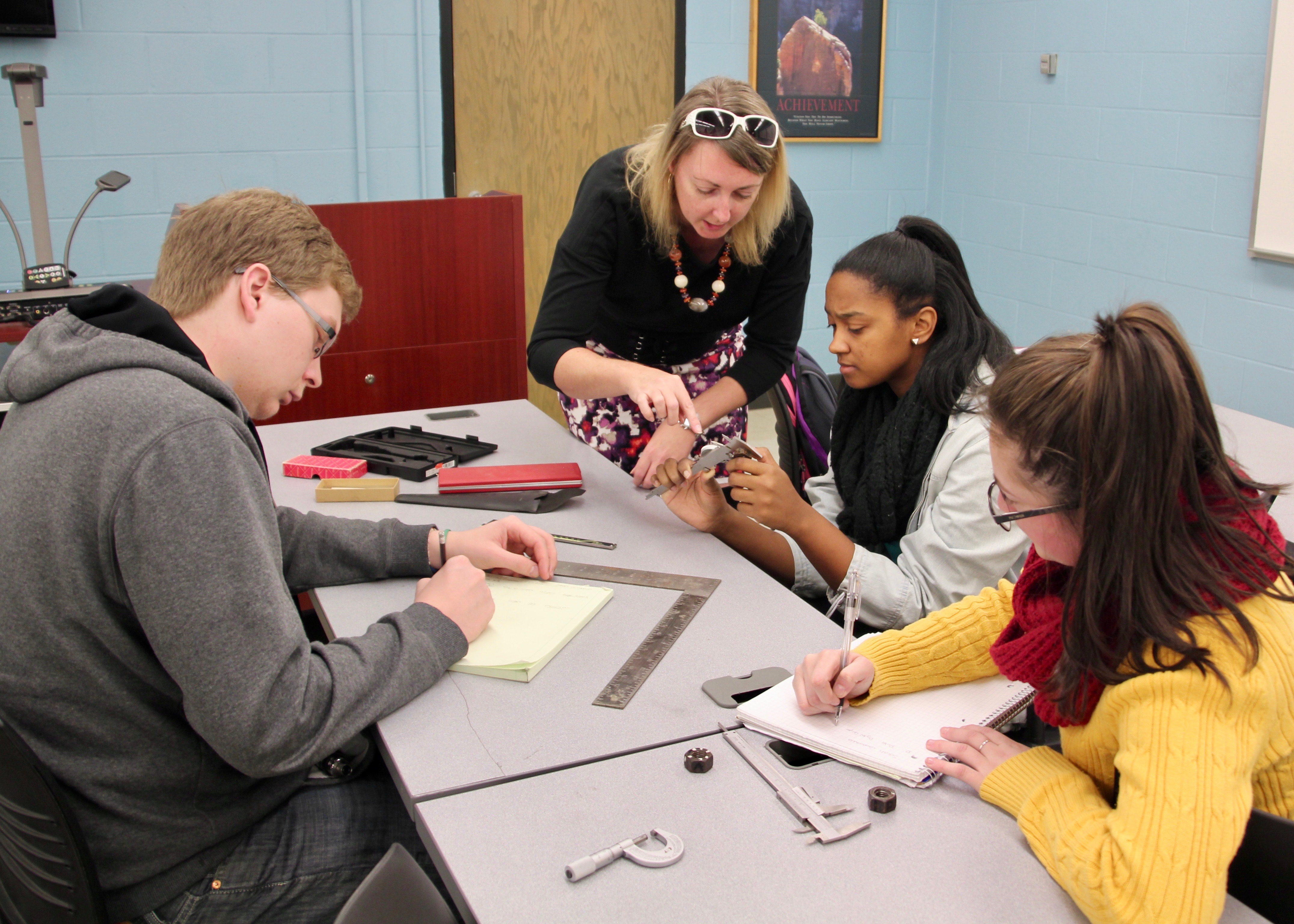 An Energy Systems Technology student monitors an HVAC device.