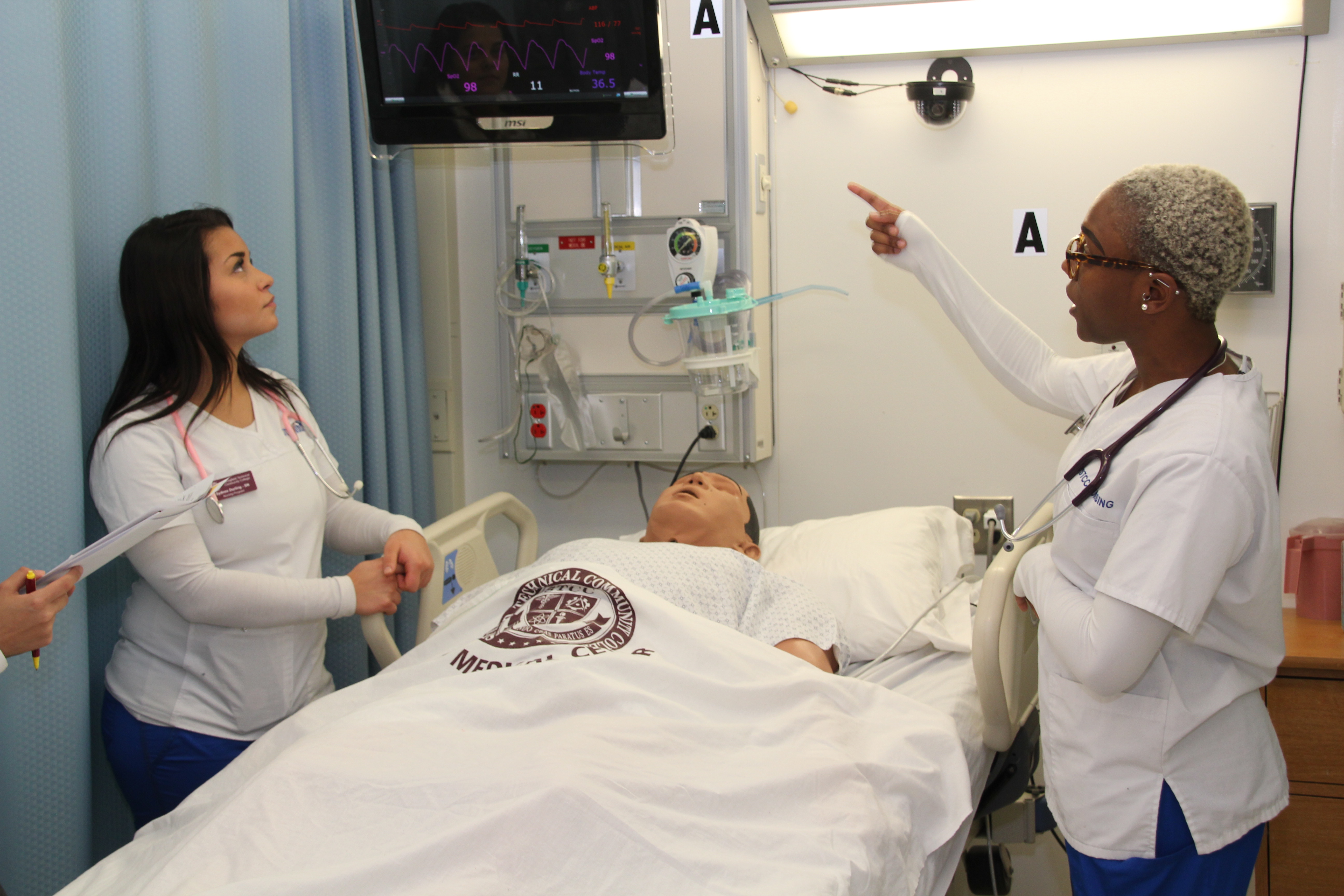 A health student cares for her SIMS patient.