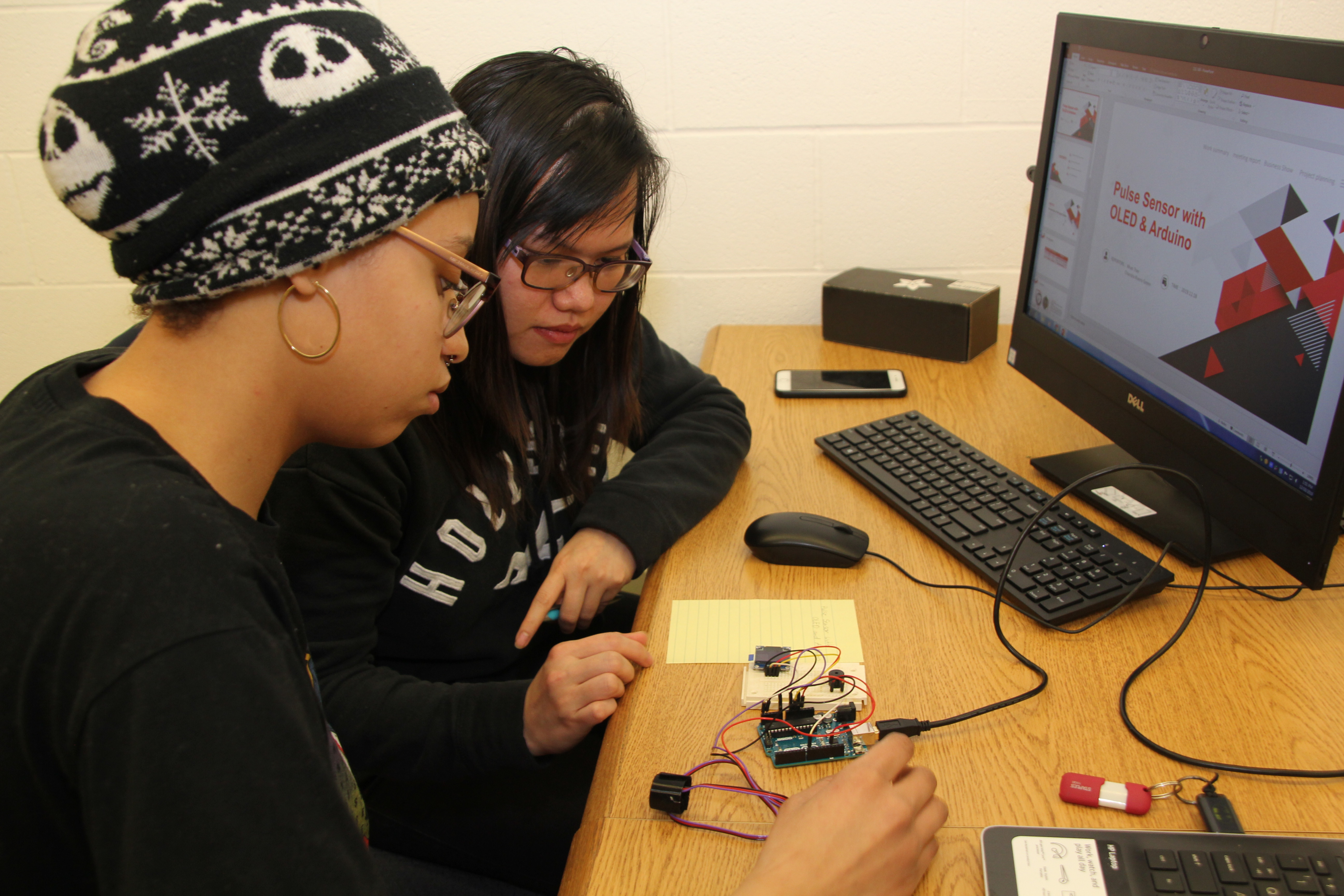 An Energy Systems Technology student monitors an HVAC device.