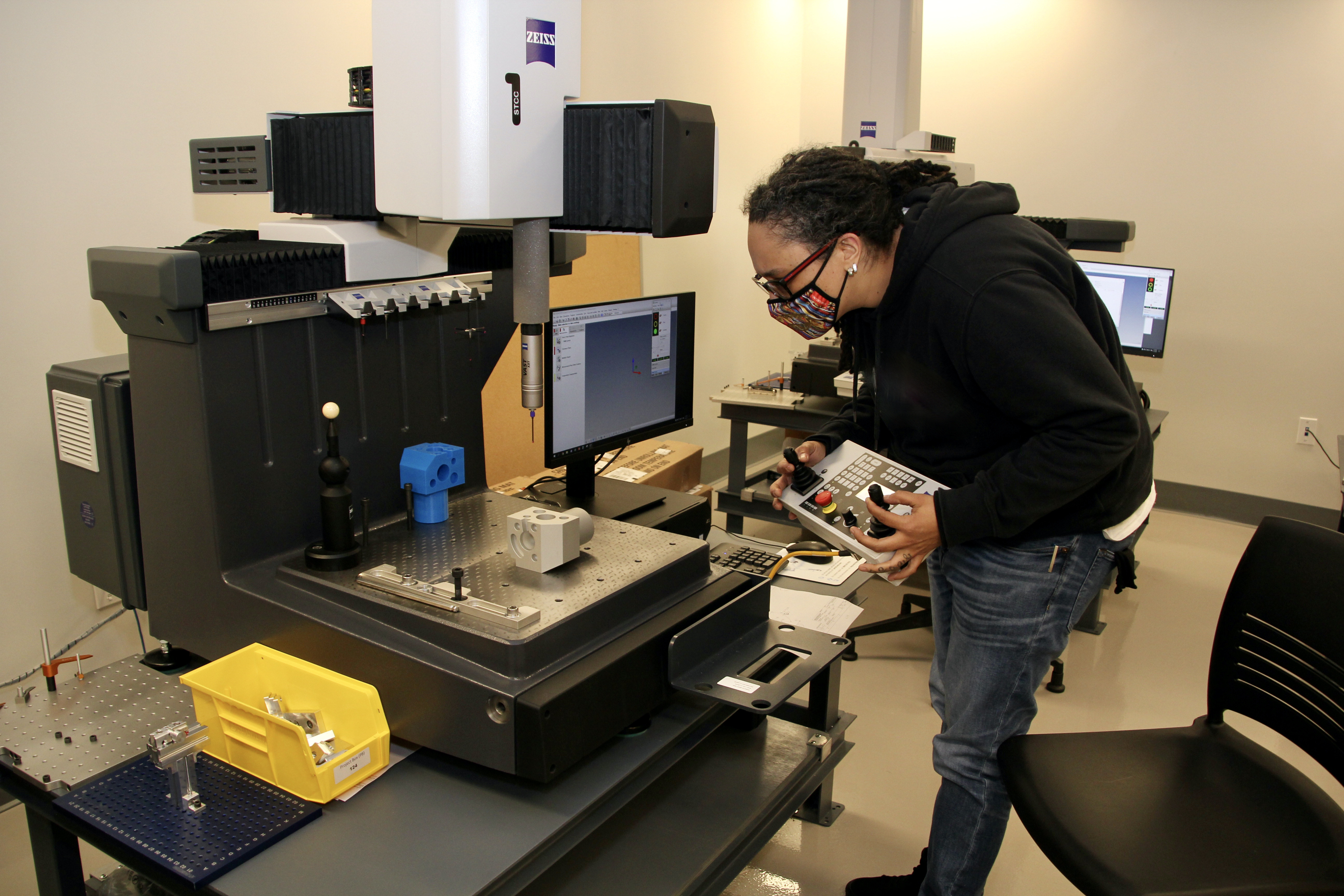 An Energy Systems Technology student monitors an HVAC device.